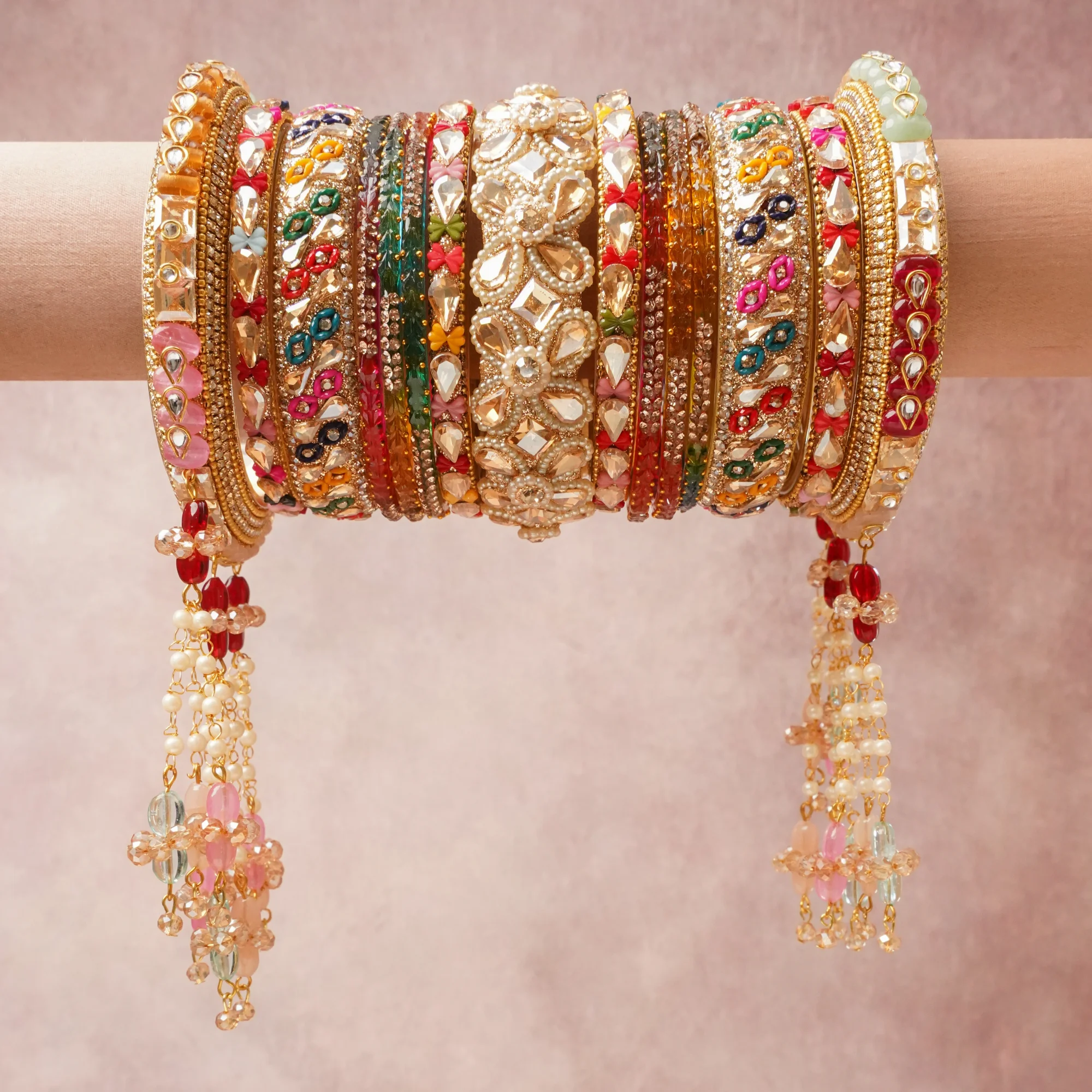 A majestic Multi colour set, complemented by Clear Crystal, Pearl White, Champagne, Rose Pink, Fuchsia, Ruby Red, Deep Crimson, Emerald Green, Teal, Sky Blue, Navy Blue, Topaz Yellow, Orange, Violet, Mint Green featuring Gold-toned Metal, Glass, Crystals, Faux Pearls, Enamel, Kundan (Simulated).
Rich, ceremonial, and designed to be passed through generations.